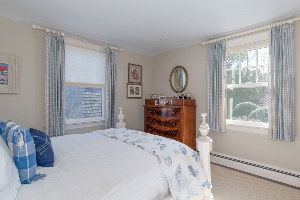 363 Jerusalem Road Cohasset, MA 02025 - Photo 37 of 42 a bedroom with a bed a closet and a large window