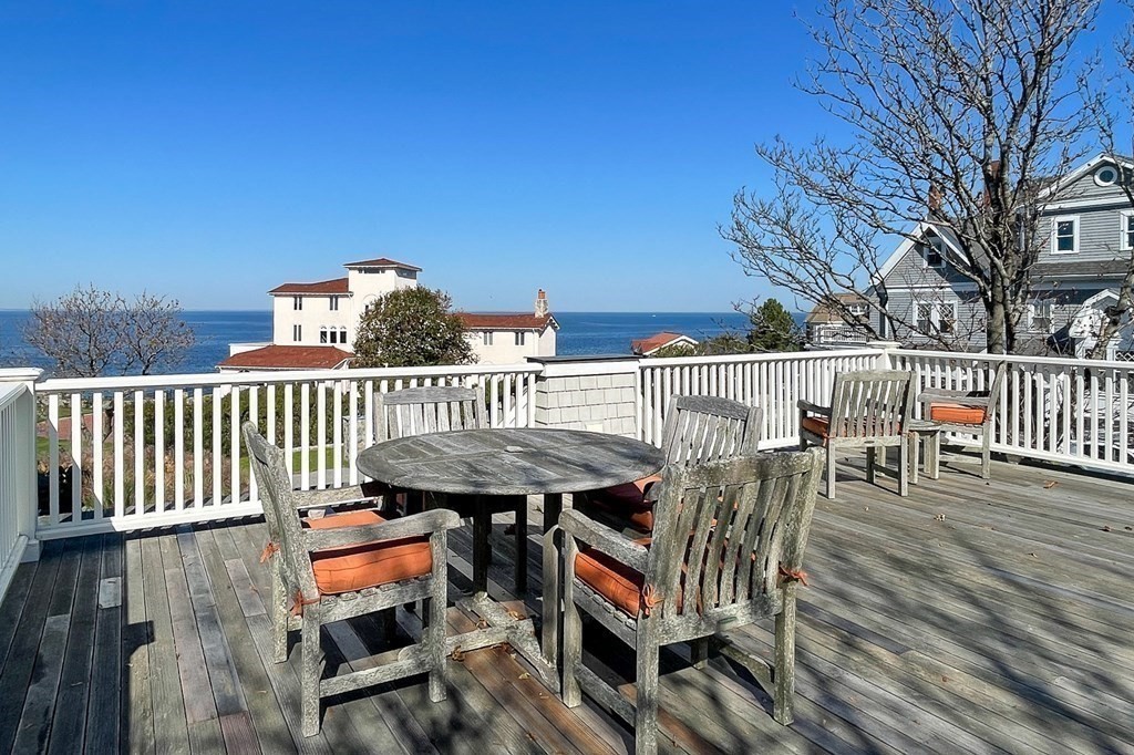 363 Jerusalem Road Cohasset, MA 02025 - Photo 9 of 42 a view of a chairs and table on the deck