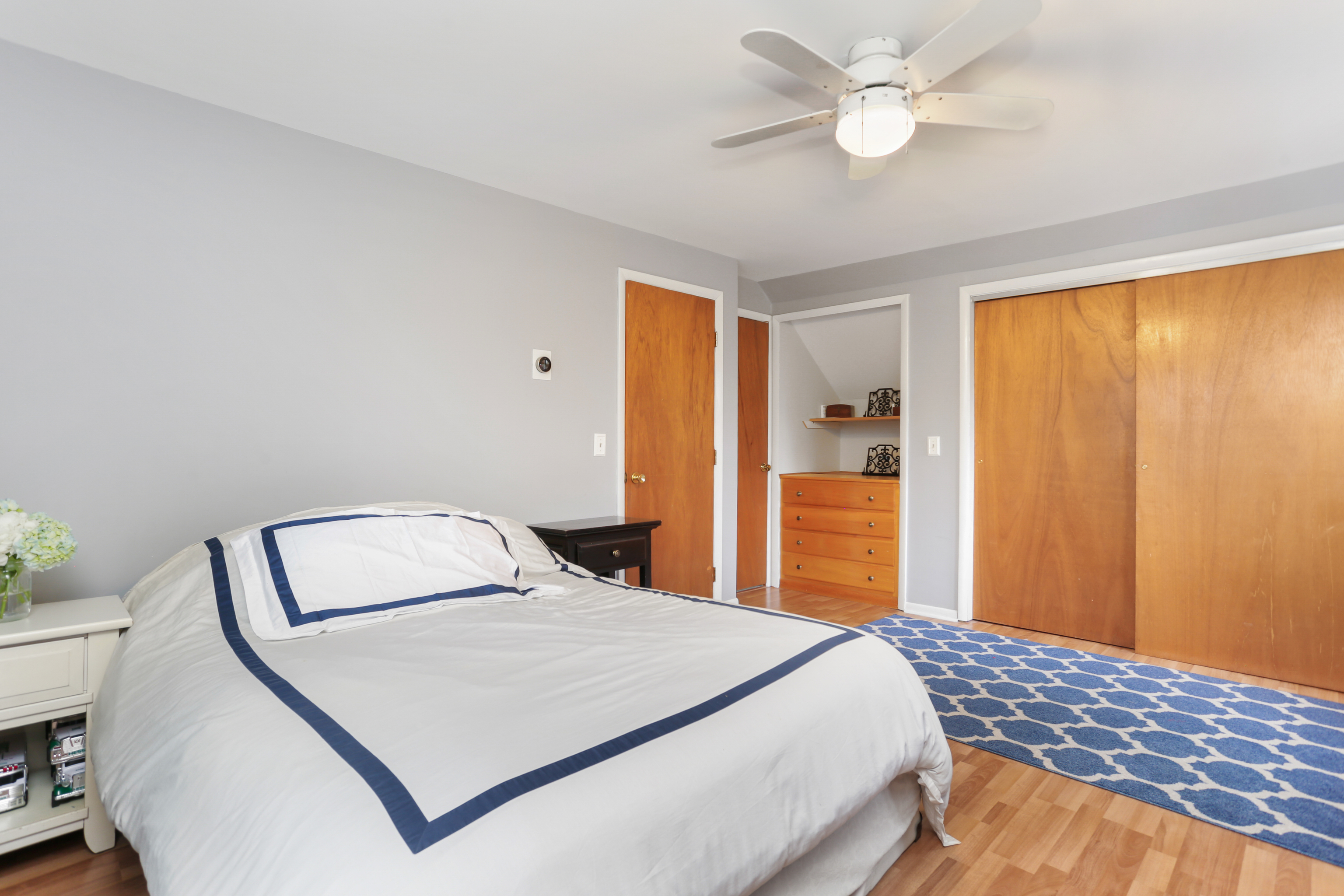 101 Soundview Avenue Fairfield, CT 06825 - Photo 20 of 40 a bedroom with a bed and a chandelier