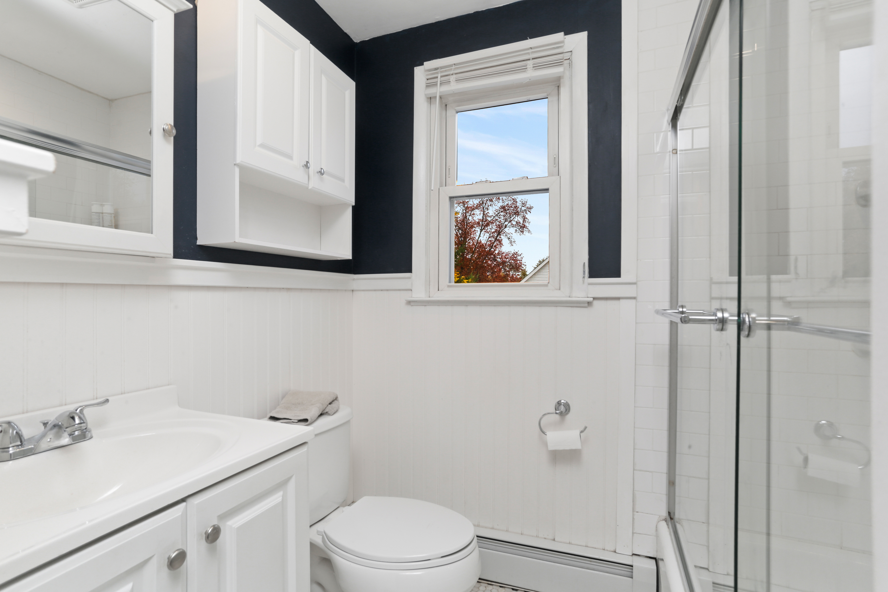 101 Soundview Avenue Fairfield, CT 06825 - Photo 23 of 40 a bathroom with a toilet sink vanity and mirror