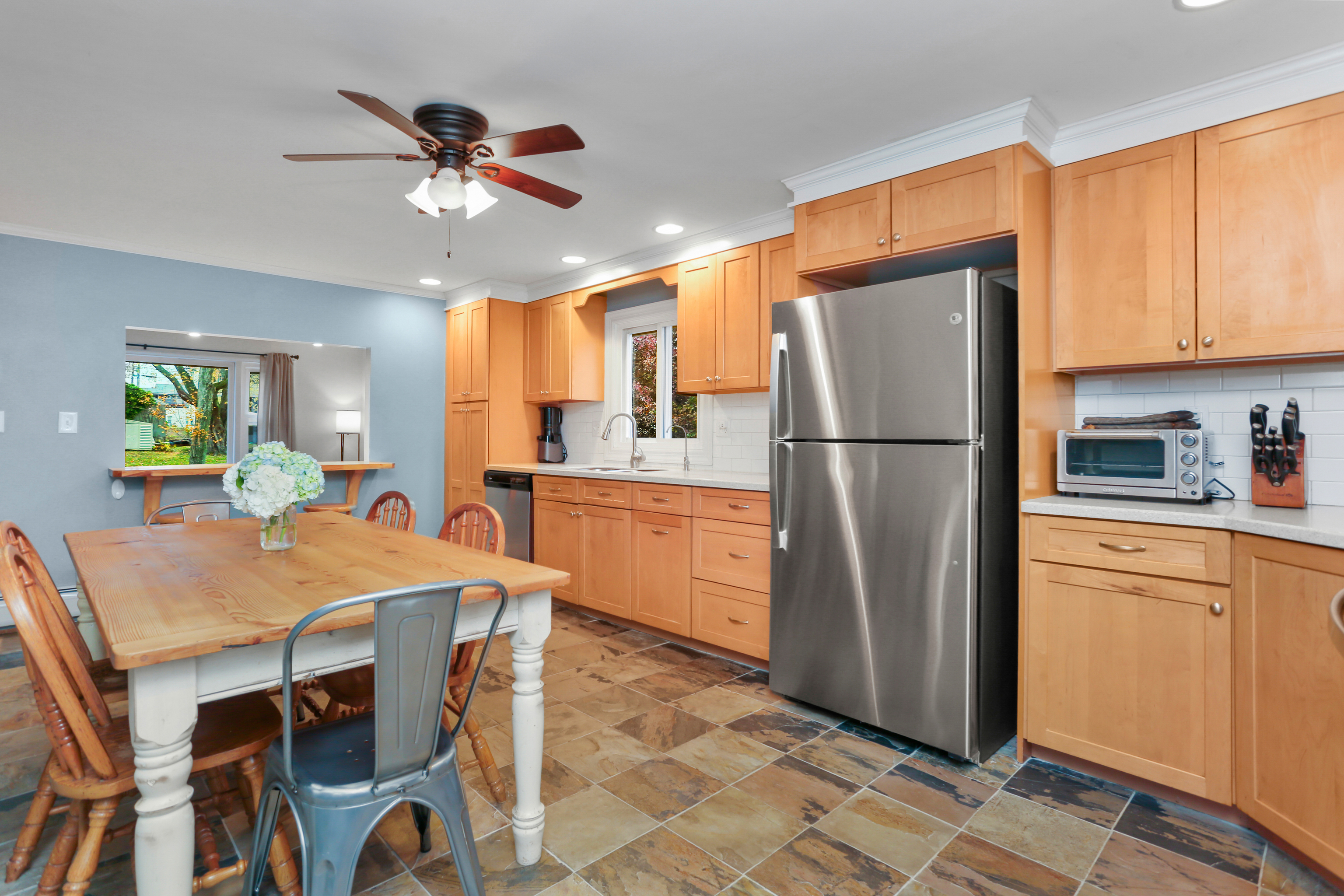 101 Soundview Avenue Fairfield, CT 06825 - Photo 7 of 40 a kitchen with stainless steel appliances granite countertop a refrigerator a sink a stove a dining table and chairs