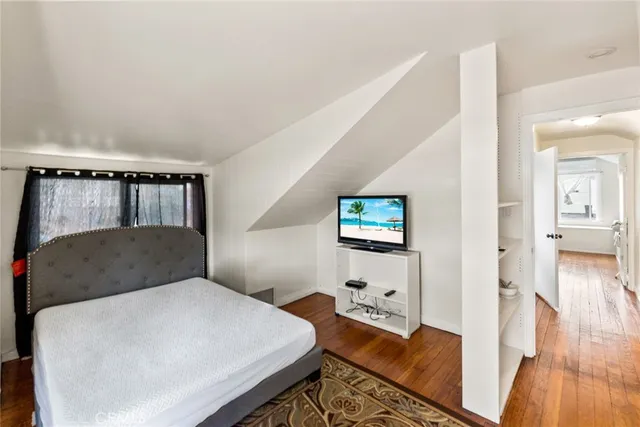a bedroom with a bed and a flat screen tv