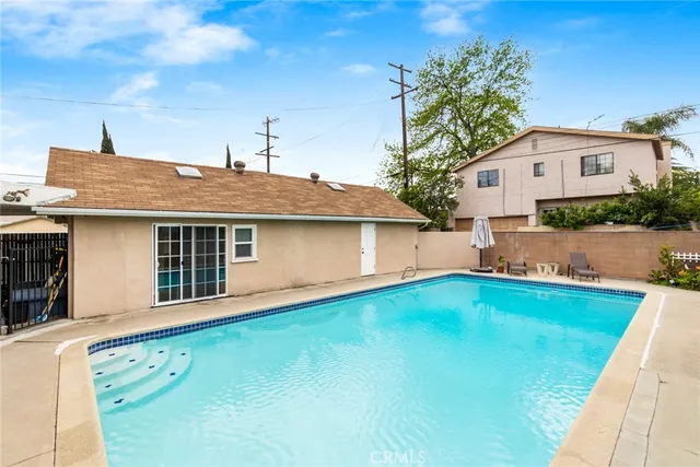 a front view of house with yard and trees in the background