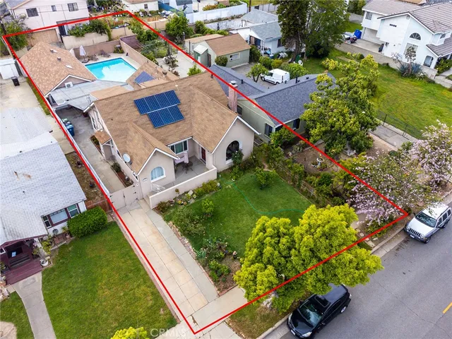 an aerial view of a house with a garden and swimming pool