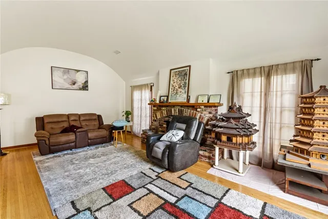 a living room with furniture a rug and a flat screen tv