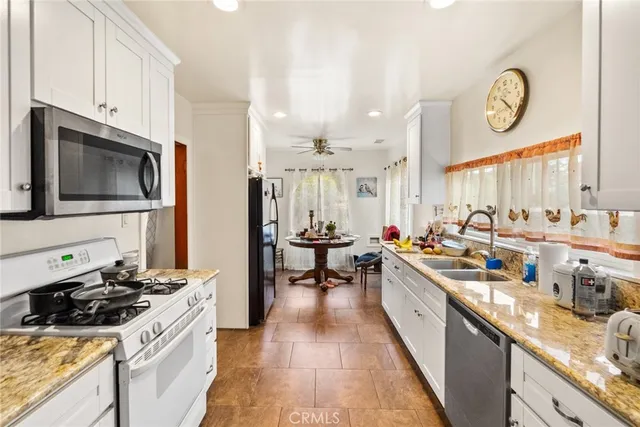 a kitchen with stainless steel appliances a stove a sink and a refrigerator