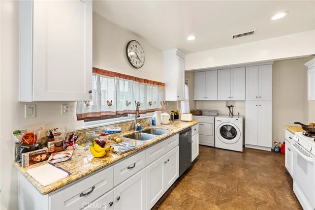 a kitchen with a stove a sink and cabinets