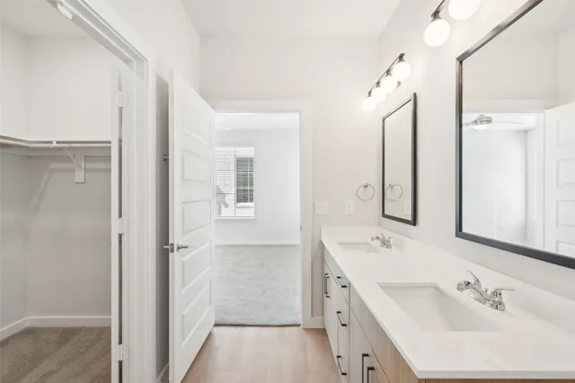 a bathroom with a double vanity sink mirror and double