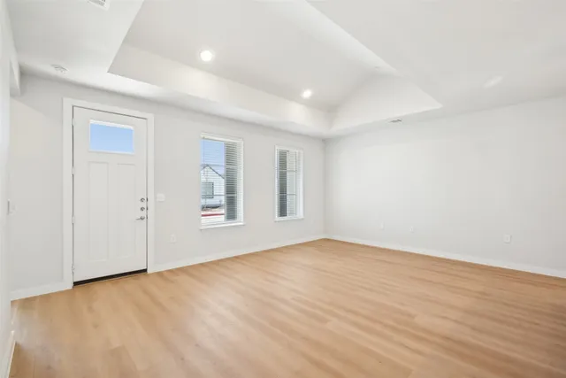 a view of an empty room with wooden floor