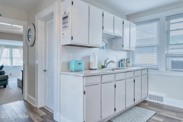 a kitchen with granite countertop a sink stove and refrigerator