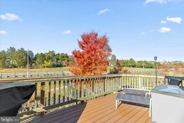 a view of a balcony with wooden floor and iron fence