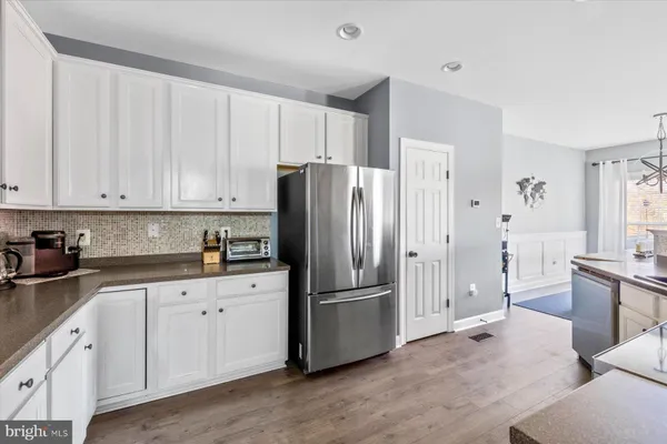 a kitchen with stainless steel appliances a refrigerator sink and cabinets