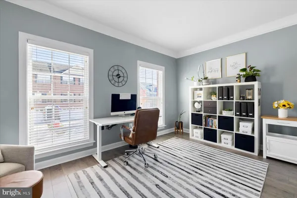 a workspace with furniture window and wooden floor