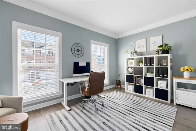 a workspace with furniture window and wooden floor
