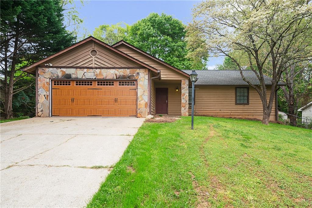 4231 Inverness Road Northwest Duluth, GA 30096 - Photo 1 of 1 a front view of a house with a garden