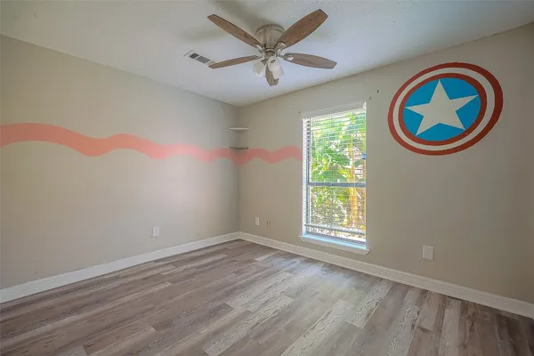wooden floor in a room next to a window