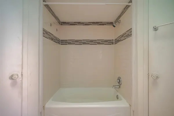 a white bath tub and shower