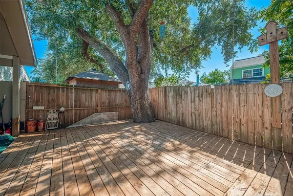 a view of a backyard with a small cabin and wooden fence