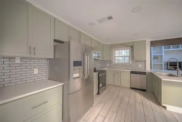 a kitchen with a white cabinets stove and refrigerator