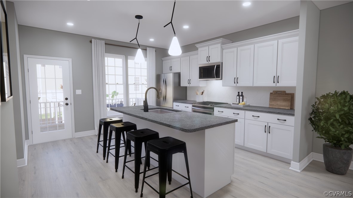 6941 Dunton Road Chesterfield, VA 23832 - Photo 4 of 7 a kitchen with granite countertop white cabinets and chairs