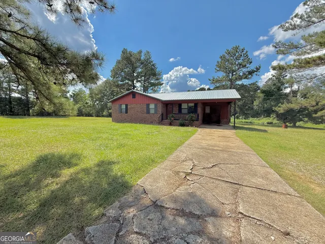 a view of a house with pool and a yard