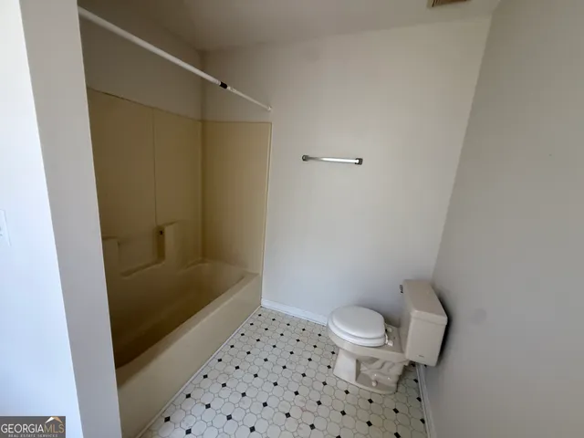 a bathroom with a shower and a toilet