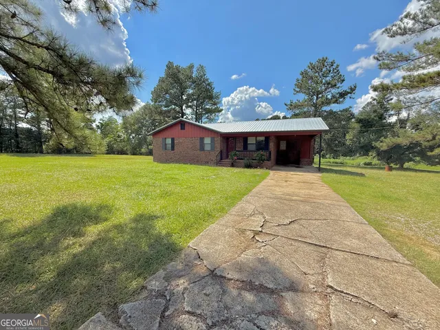 a view of house with garden space and street view