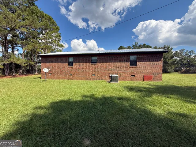 a front view of house with yard and outdoor seating