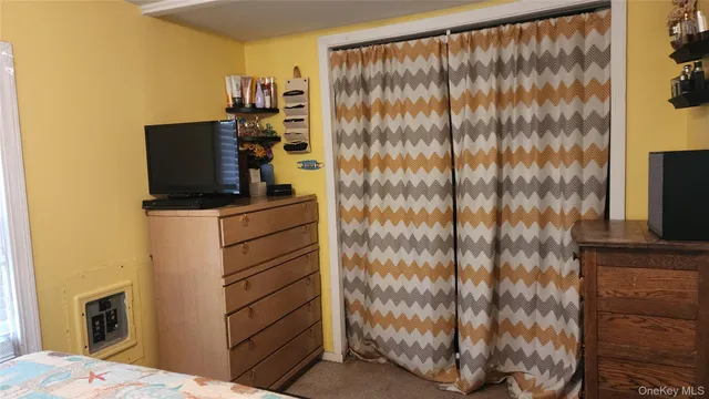 a bathroom with a shower curtain and mirror