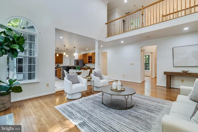 a kitchen with stainless steel appliances kitchen island granite countertop a stove a refrigerator a sink a table and chairs