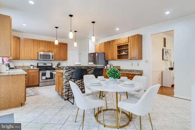 a kitchen with granite countertop a sink a counter top space appliances and cabinets
