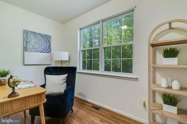 a bedroom with a large bed a chandelier and a window
