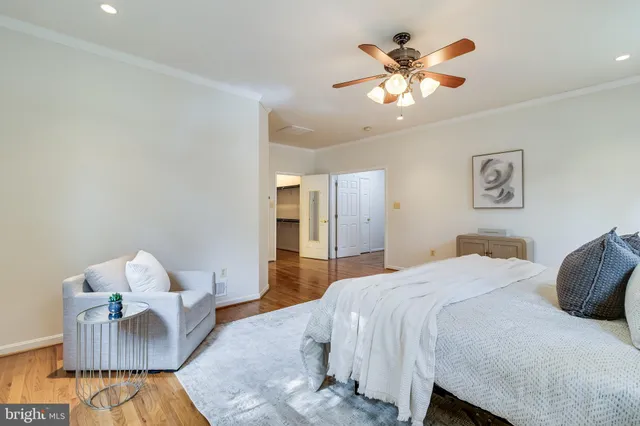 a view of a hallway with wooden floor and closet