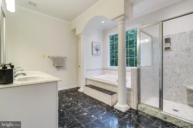 a view of walk in closet with wooden floor