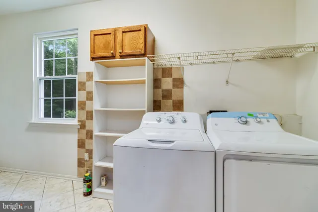 a spacious bathroom with a double vanity sink large mirror and a bathtub
