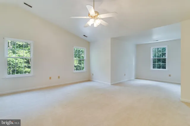 a view of staircase with railing and a chandelier
