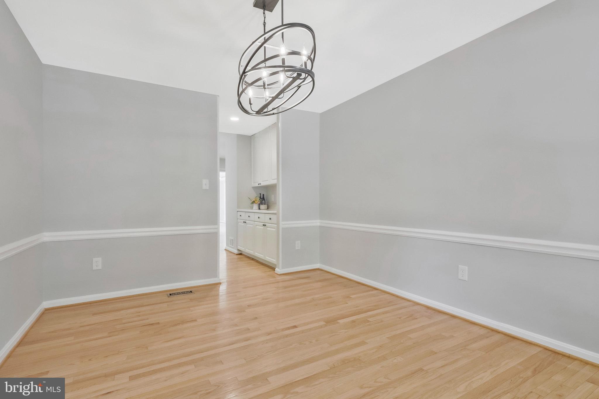 8606 Nanlee Drive Springfield, VA 22152 - Photo 12 of 70 a view of a room with wooden floor and white walls