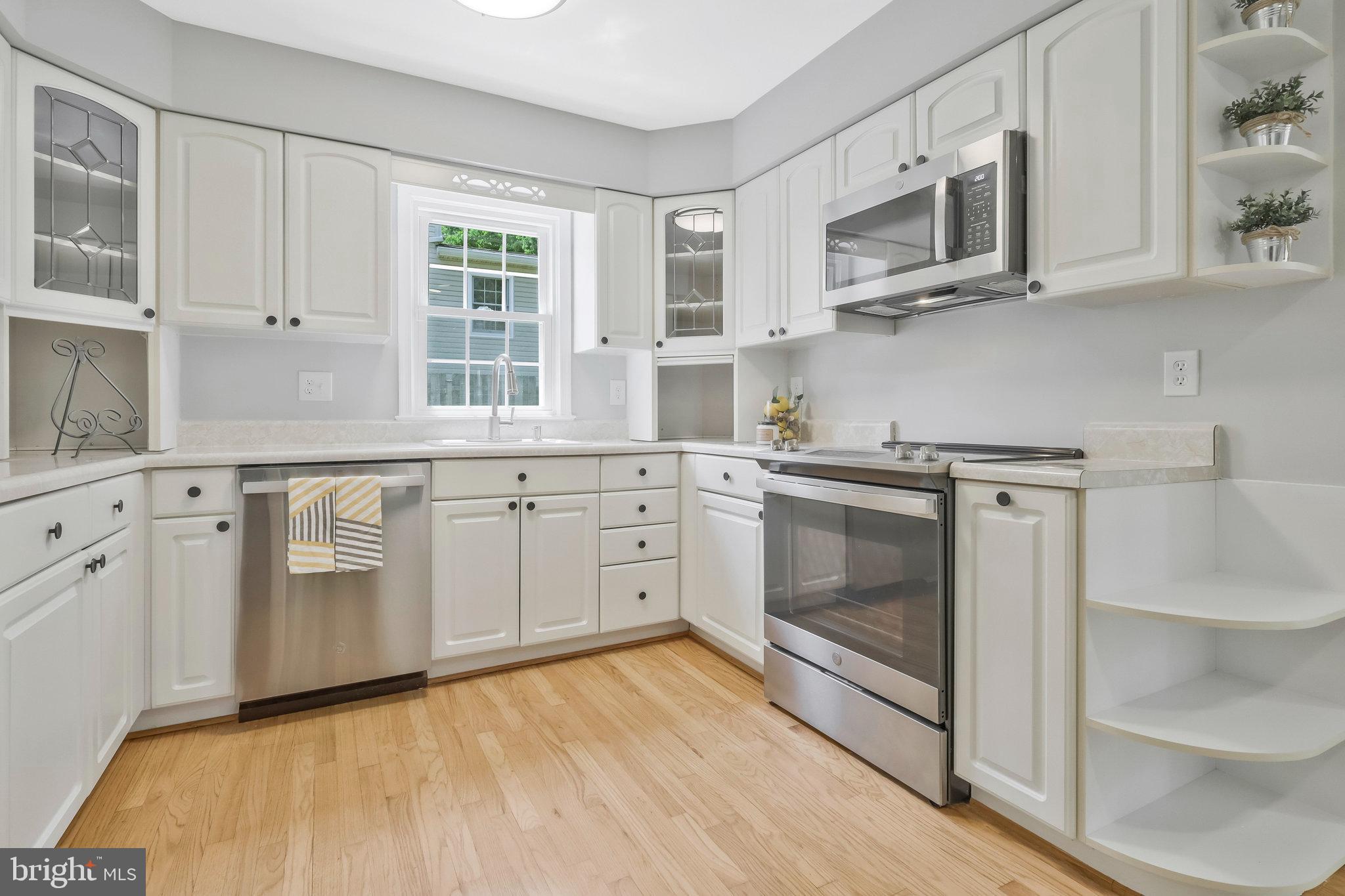 8606 Nanlee Drive Springfield, VA 22152 - Photo 13 of 70 a kitchen with stainless steel appliances granite countertop a stove a sink and a microwave