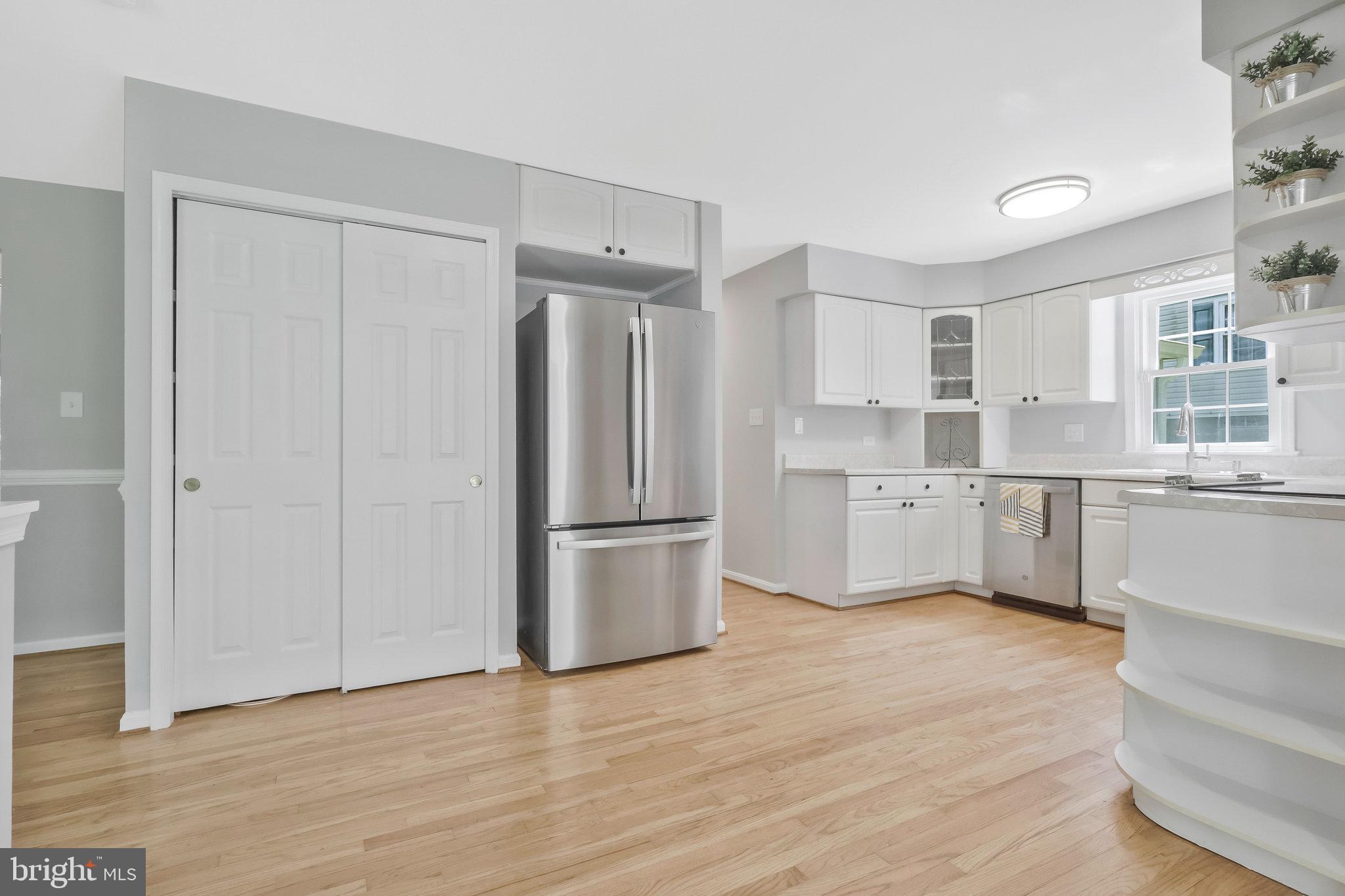 8606 Nanlee Drive Springfield, VA 22152 - Photo 17 of 70 a kitchen with a refrigerator a sink and cabinets