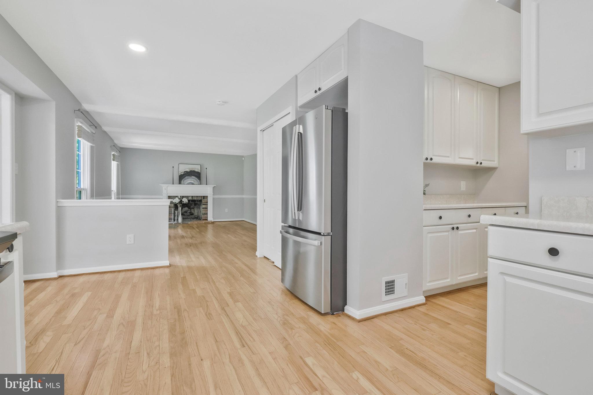 8606 Nanlee Drive Springfield, VA 22152 - Photo 20 of 70 a view of a kitchen with wooden floor and electronic appliances