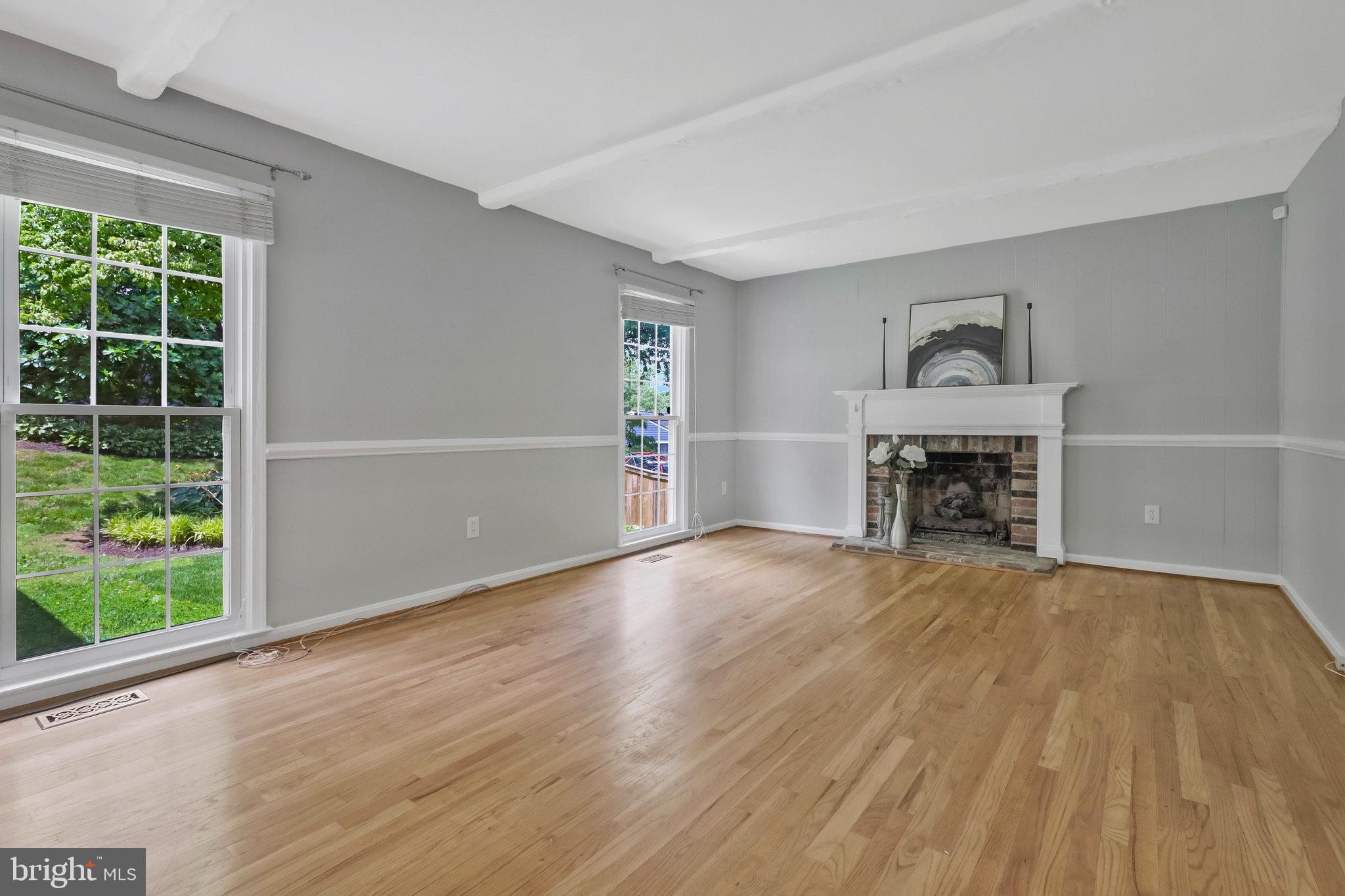8606 Nanlee Drive Springfield, VA 22152 - Photo 24 of 70 a view of empty room with wooden floor and fireplace