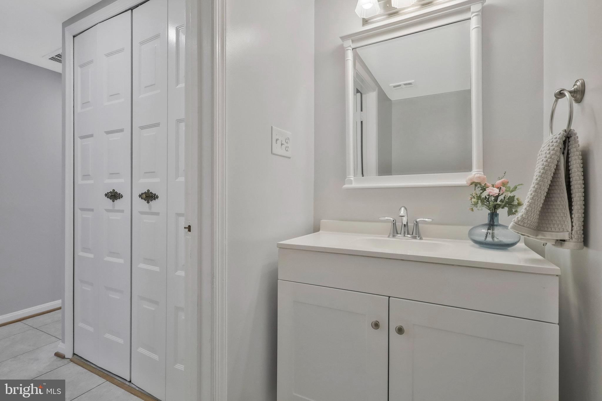 8606 Nanlee Drive Springfield, VA 22152 - Photo 27 of 70 a bathroom with a granite countertop sink vanity mirror and