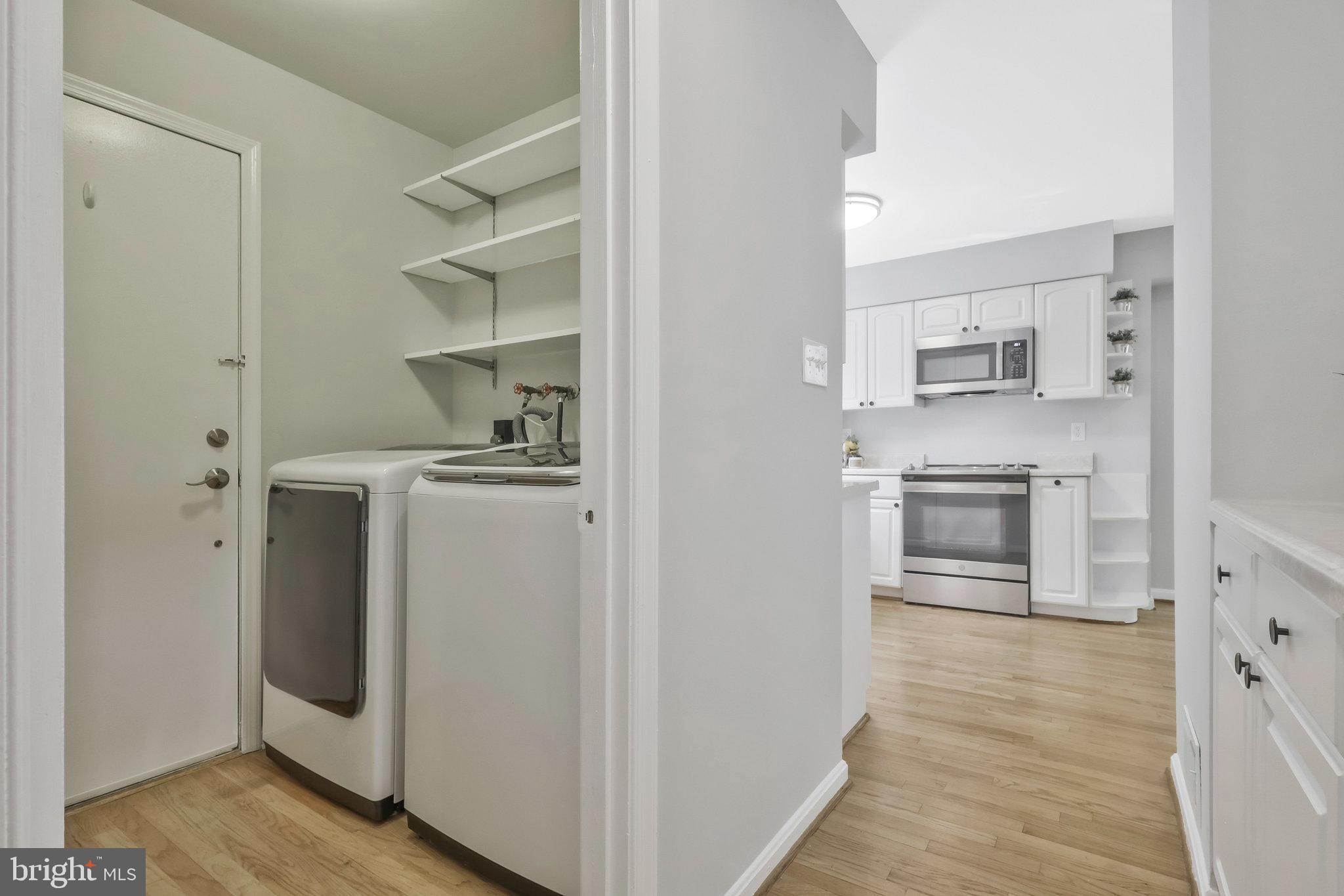 8606 Nanlee Drive Springfield, VA 22152 - Photo 29 of 70 a kitchen with white cabinets and wooden floor