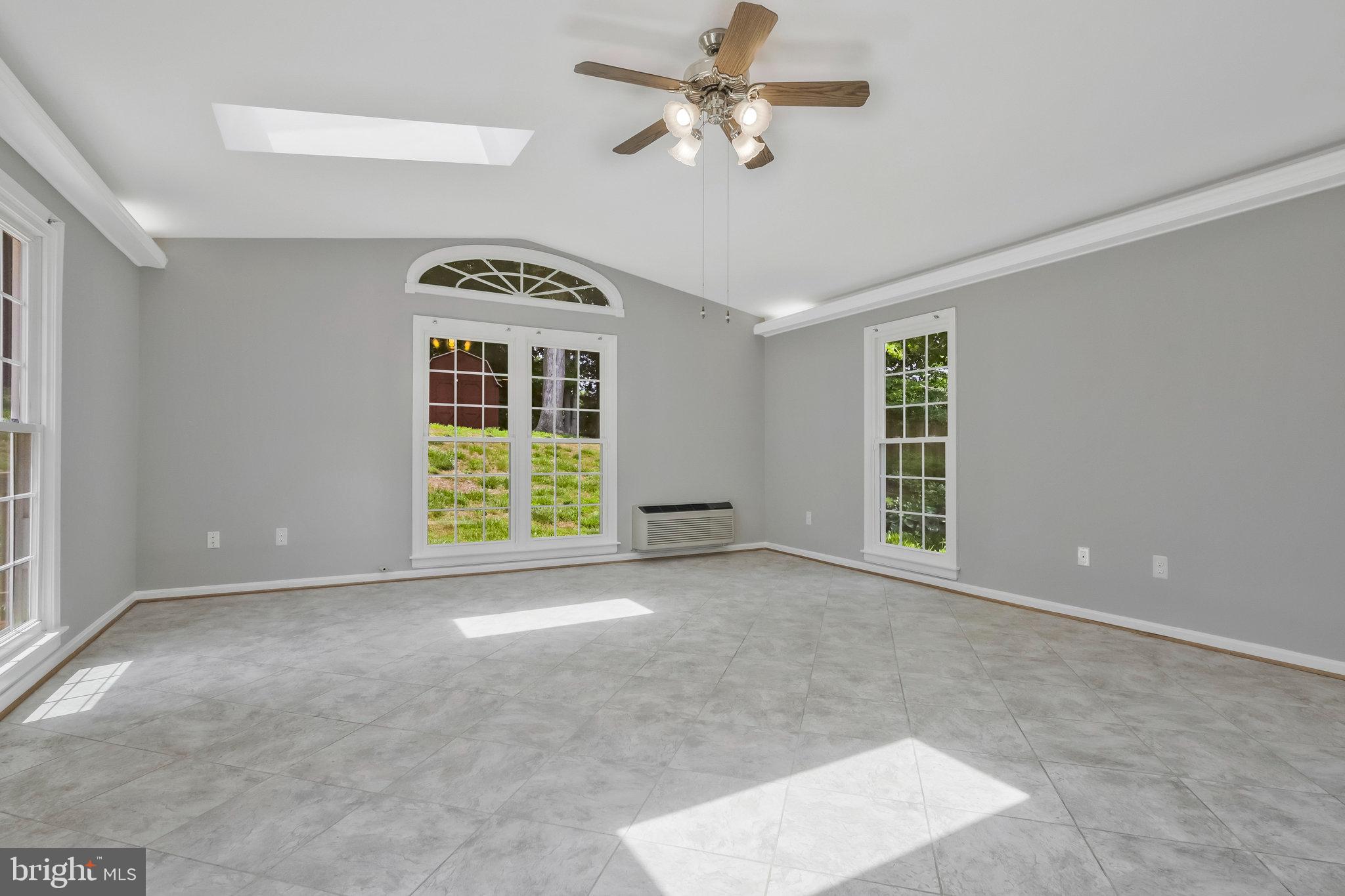 8606 Nanlee Drive Springfield, VA 22152 - Photo 33 of 70 a view of a livingroom with a ceiling fan and window