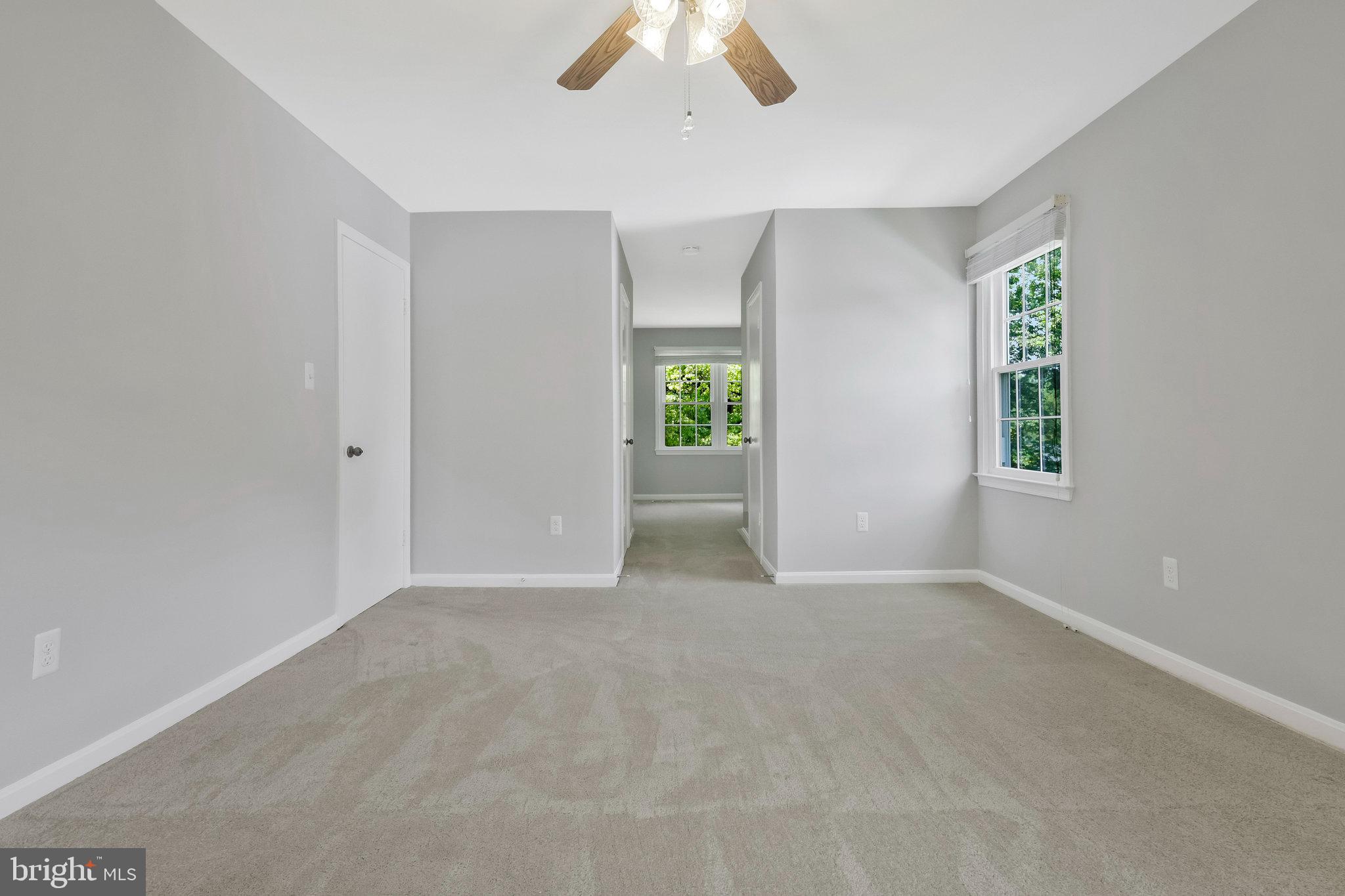 8606 Nanlee Drive Springfield, VA 22152 - Photo 39 of 70 an empty room with windows and chandelier fan