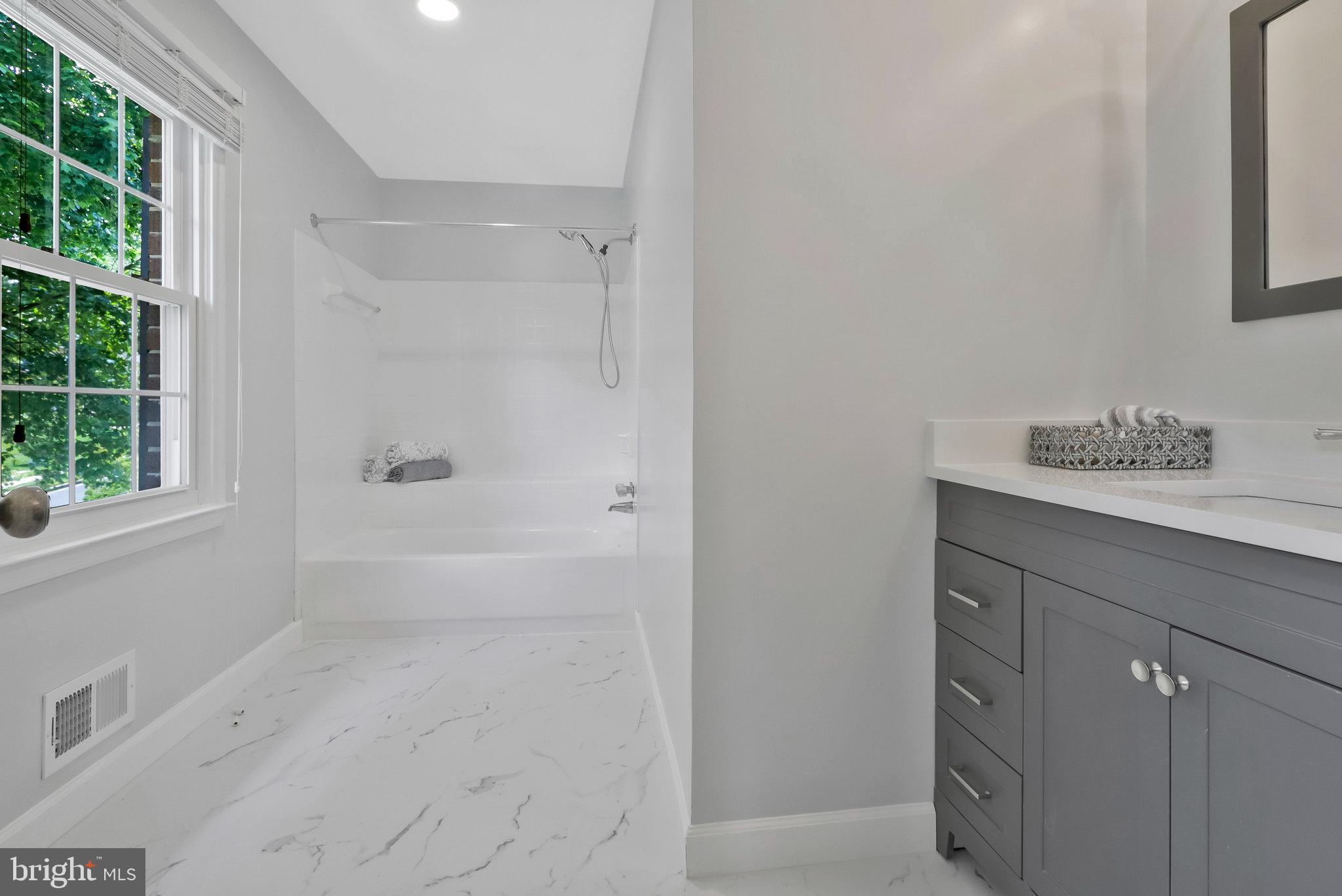 8606 Nanlee Drive Springfield, VA 22152 - Photo 41 of 70 a bathroom with a shower sink and vanity