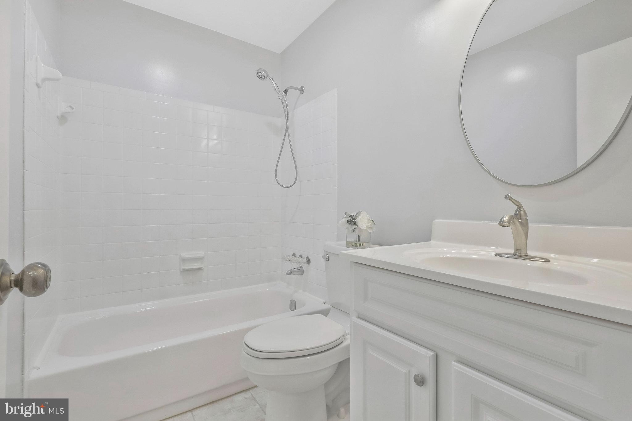 8606 Nanlee Drive Springfield, VA 22152 - Photo 54 of 70 a bathroom with a sink a toilet and a mirror