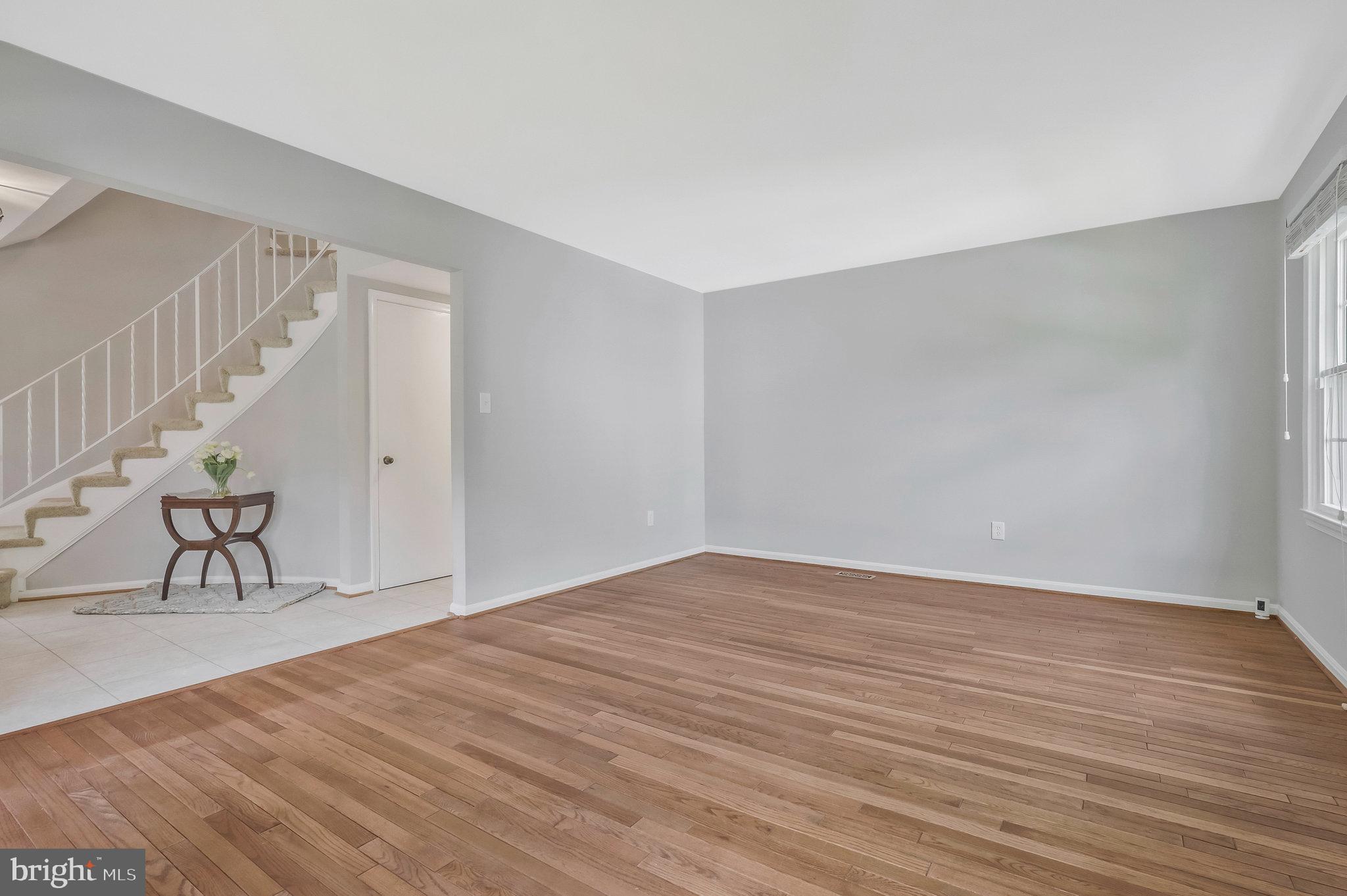 8606 Nanlee Drive Springfield, VA 22152 - Photo 7 of 70 a view of an empty room with wooden floor and a window