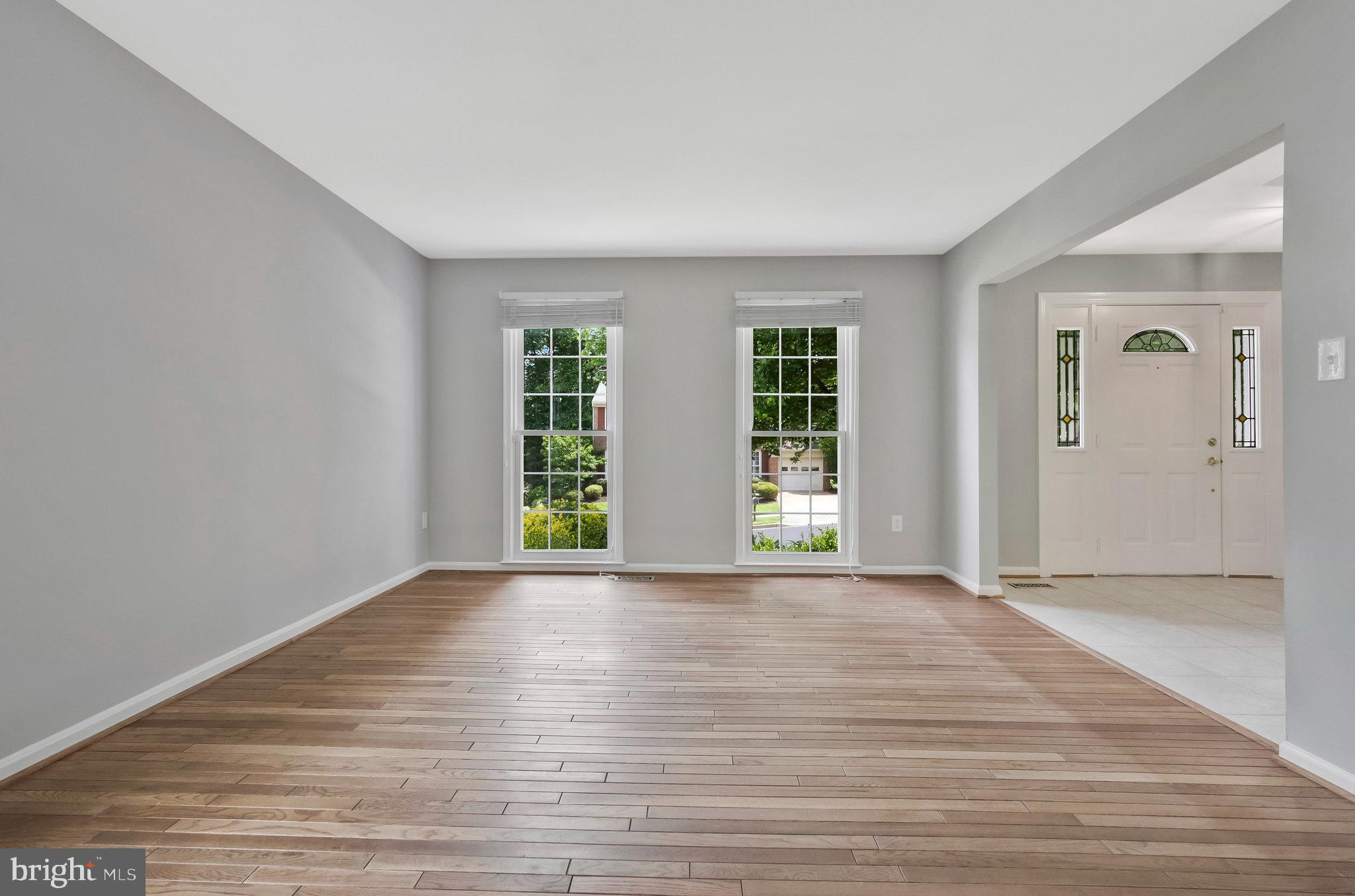 8606 Nanlee Drive Springfield, VA 22152 - Photo 8 of 70 a view of an empty room with wooden floor and windows