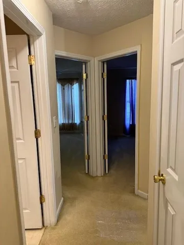 an empty room with a ceiling fan and window